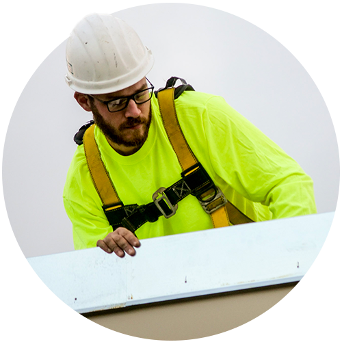 Total Roofing Services team member installing roofing material